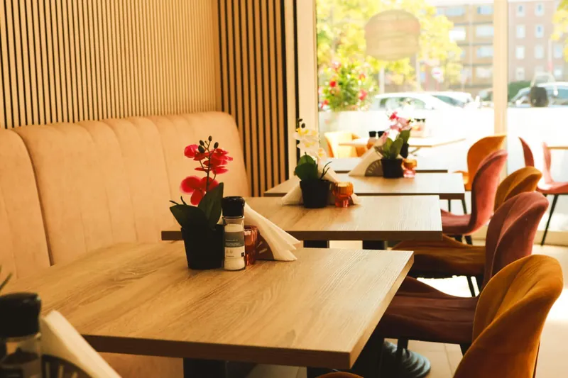 Houten tafels en banken met verse bloemen in de zaal